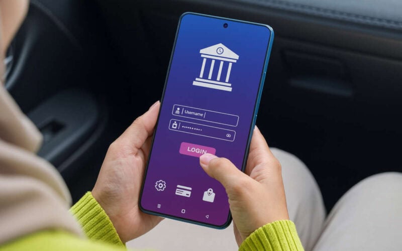 Persona accede a un’app bancaria da smartphone per effettuare bonifici 2025, con login protetto e interfaccia digitale moderna.