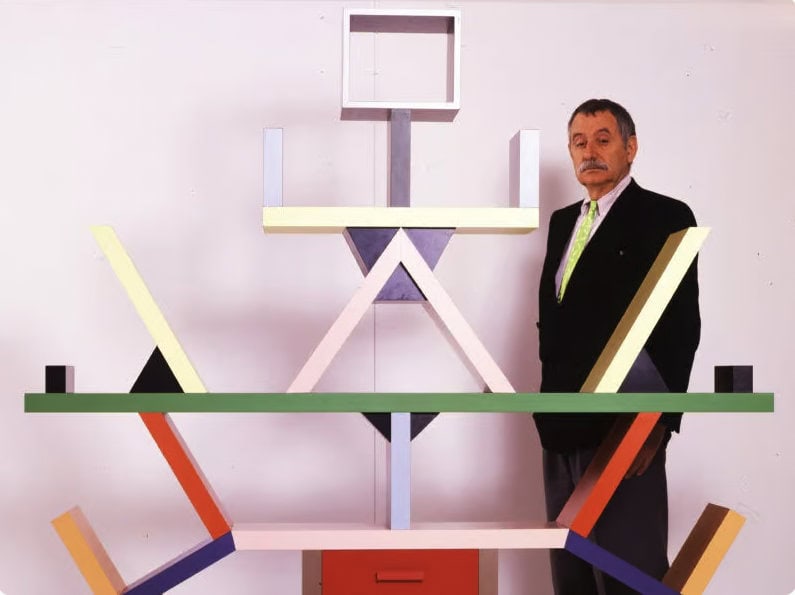 Designer italiani famosi: Ettore Sottsass accanto alla libreria Carlton del movimento Memphis